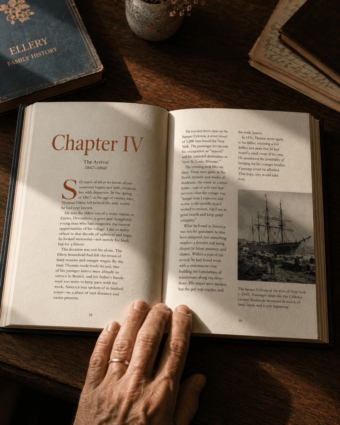 An open hardcover family history book on a walnut table, a reader's hand resting at the page edge